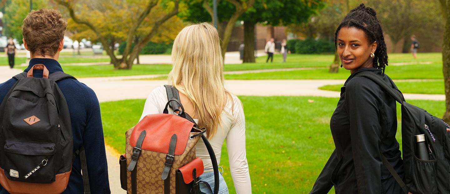 Three students walking on Oakland University campus